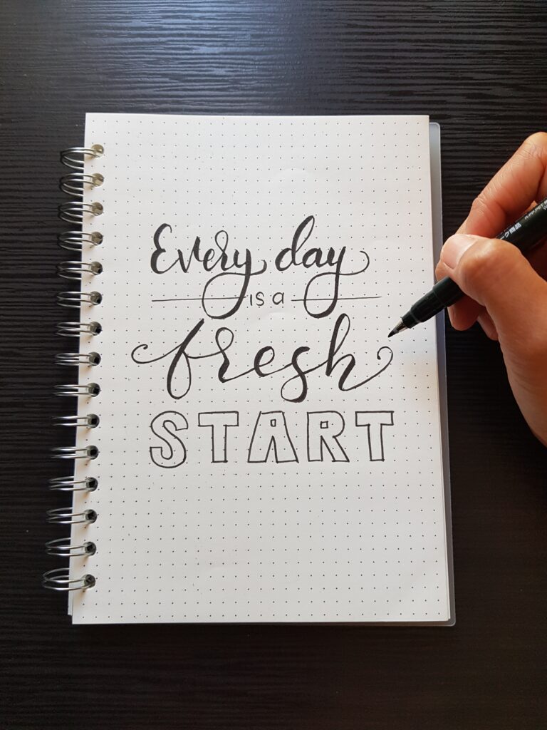 Hand-drawn lettering that reads, "Every day is a fresh start"