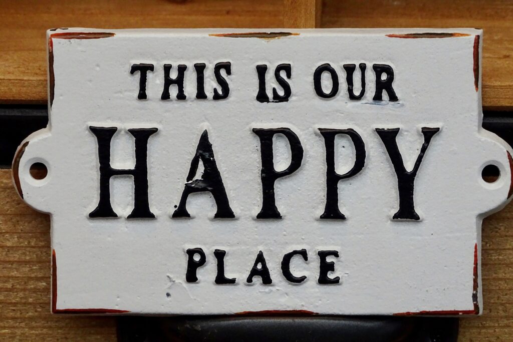 A rustic plaque that reads, "This is our happy place".